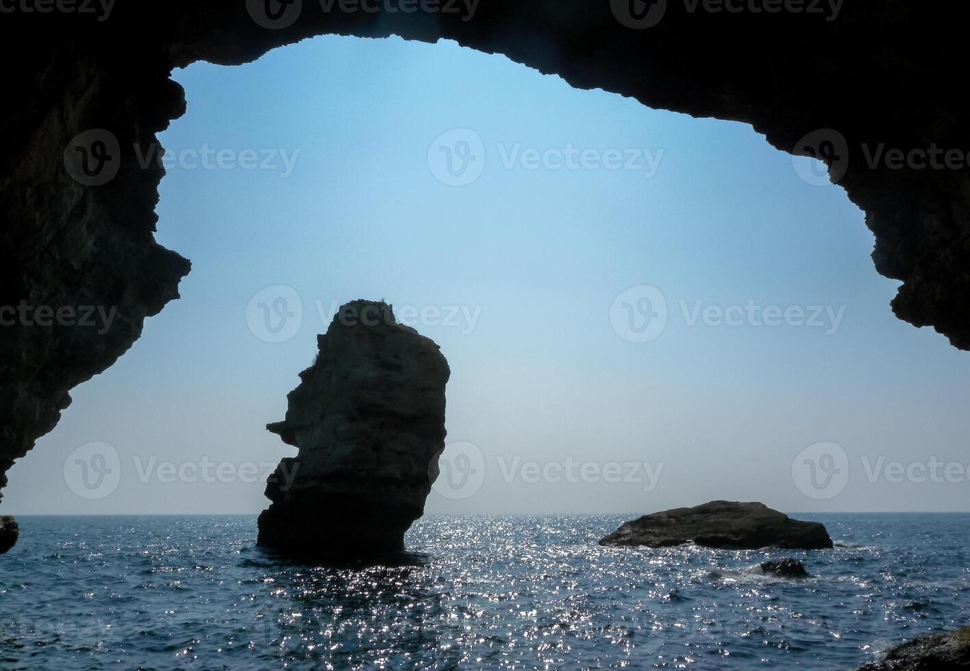 View of the rocks from a stone arch in the sea near the village of Tyulenovo, Bulgaria photo