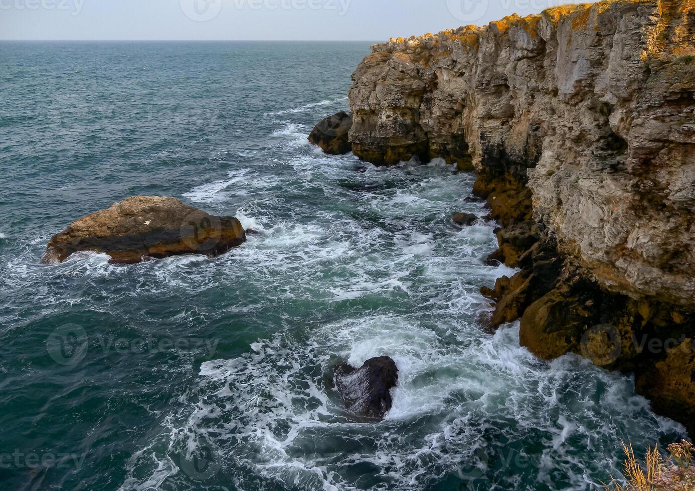 Seascape on the Black Sea, high steep stone coast with inaccessible rocks near the village of Tyulenovo, Bulgaria photo
