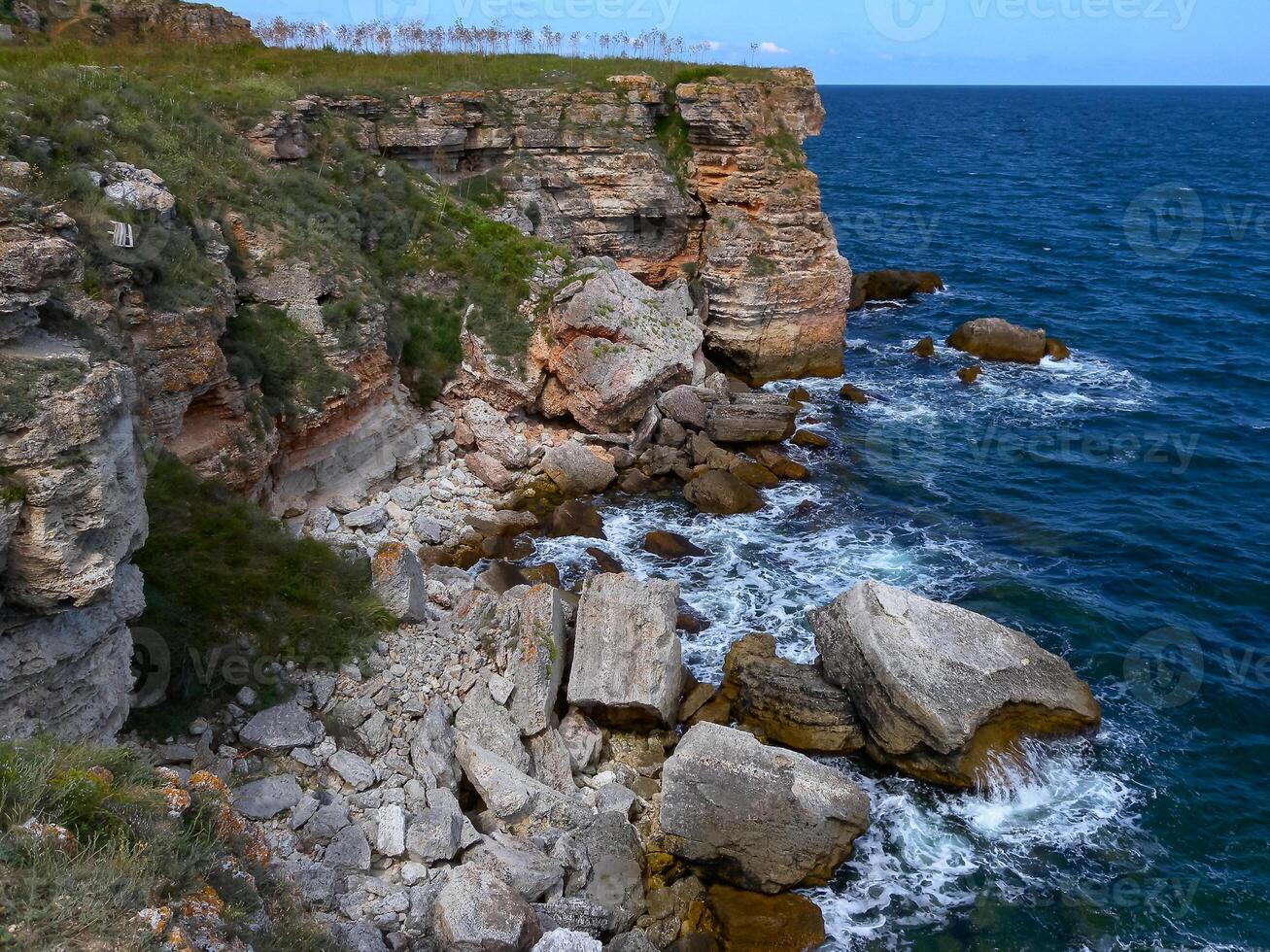 Seascape on the Black Sea, Vysoky Steep stone coast with inaccessible rocks near the village of Tyulenovo, Bulgaria photo