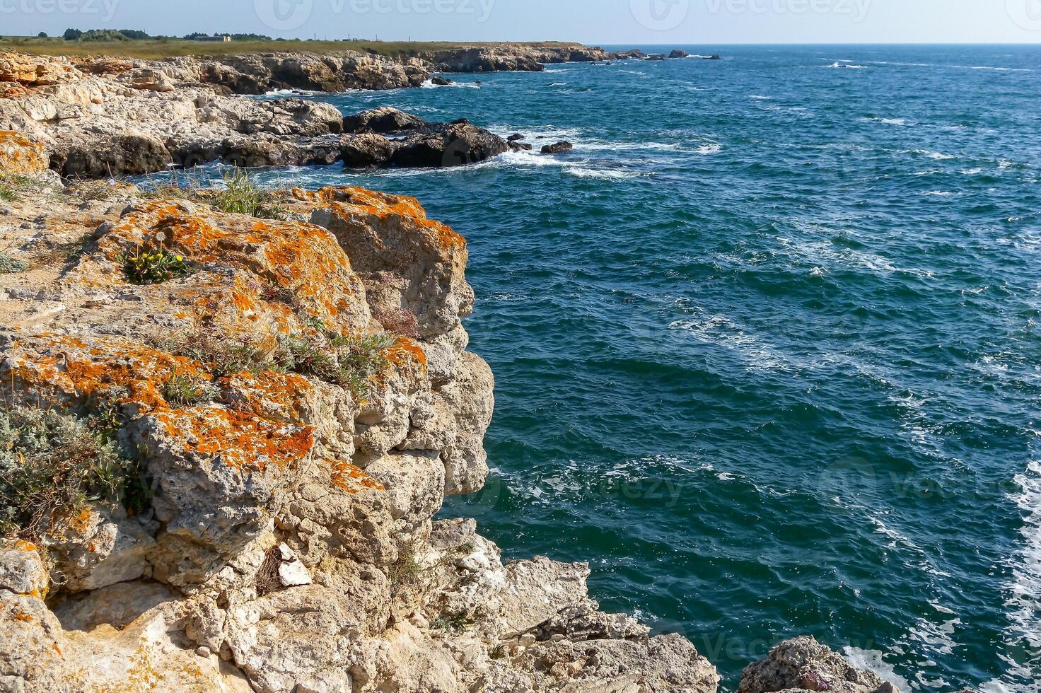 Seascape on the Black Sea, Vysoky Steep stone coast with inaccessible rocks near the village of Tyulenovo, Bulgaria photo