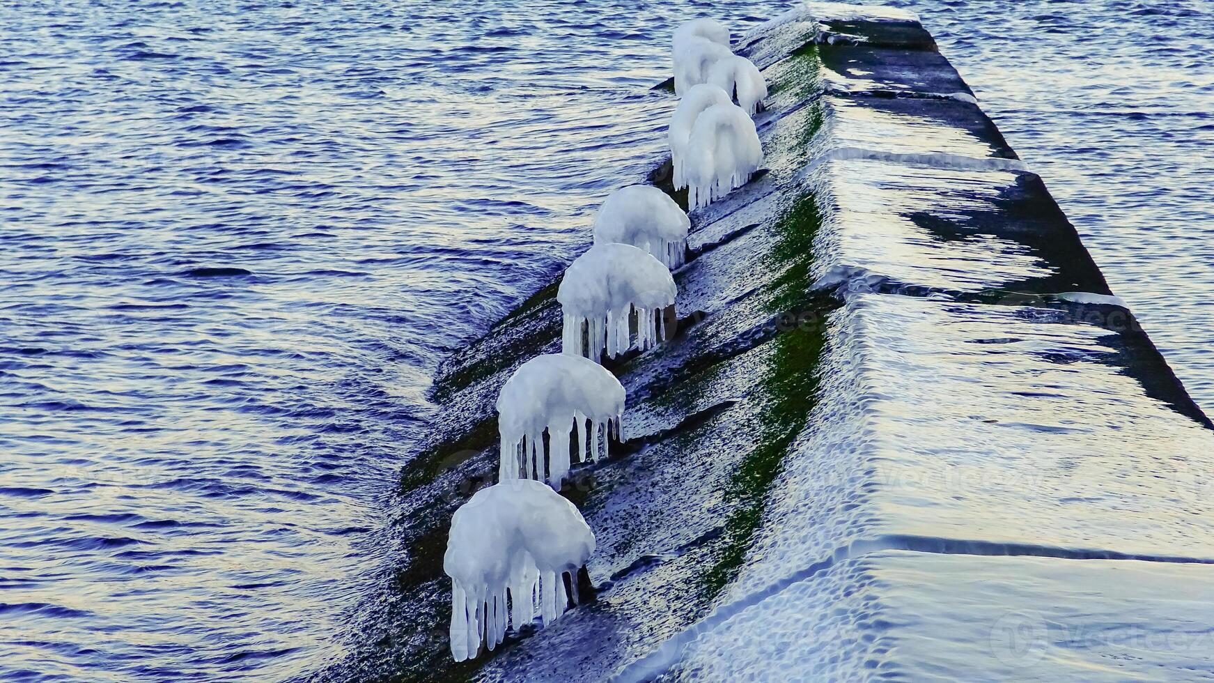 View of the icy pier on the beach in Arcadia in winter, Odessa, Ukraine photo