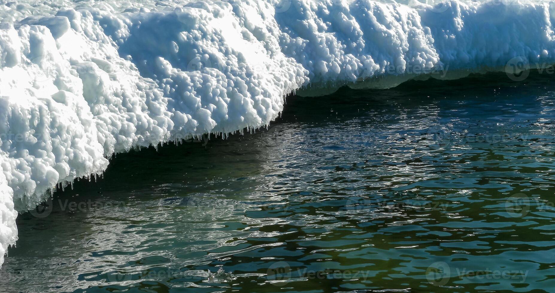 Frozen Black Sea, blocks of melting ice on the seashore photo