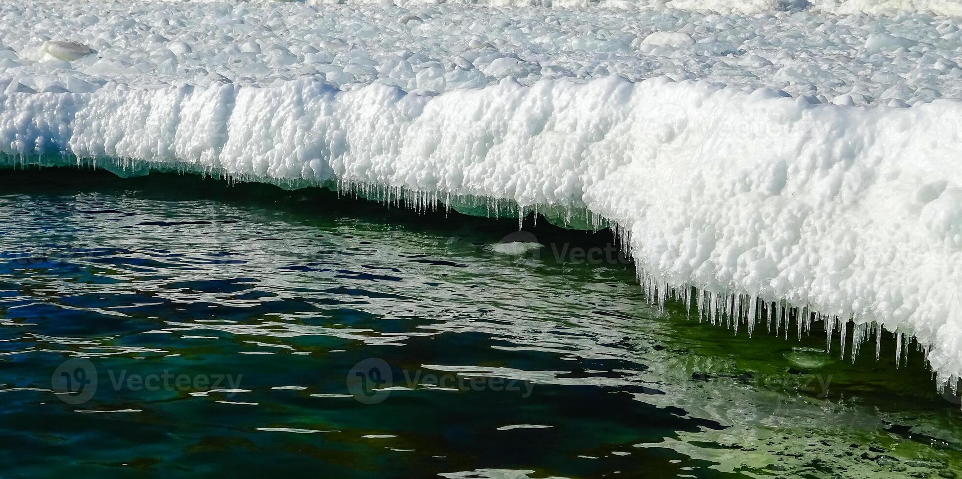 Frozen Black Sea, blocks of melting ice on the seashore photo