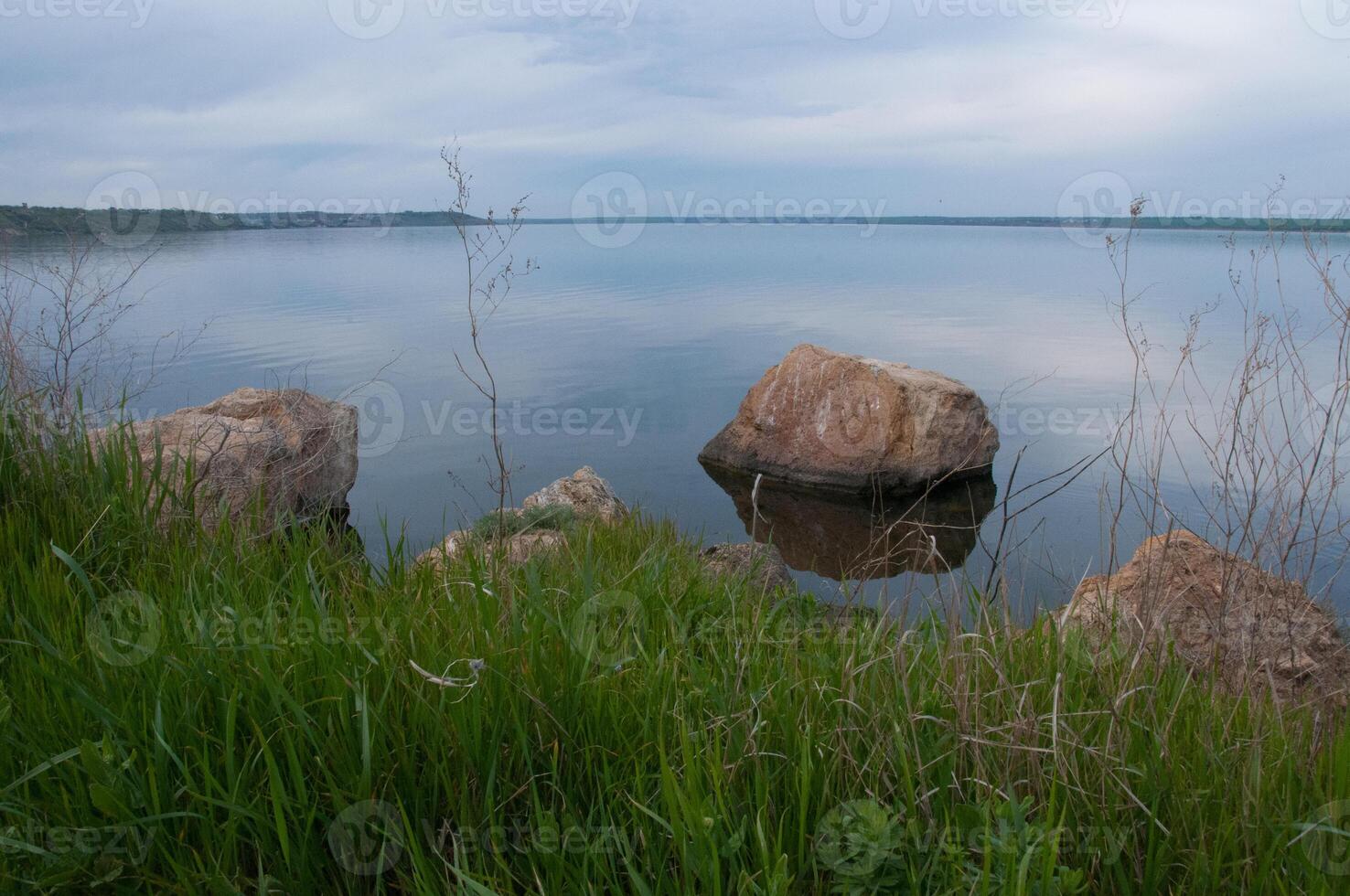 Coast with rocks in the water, Hadzhibey estuary. Reflection in water photo