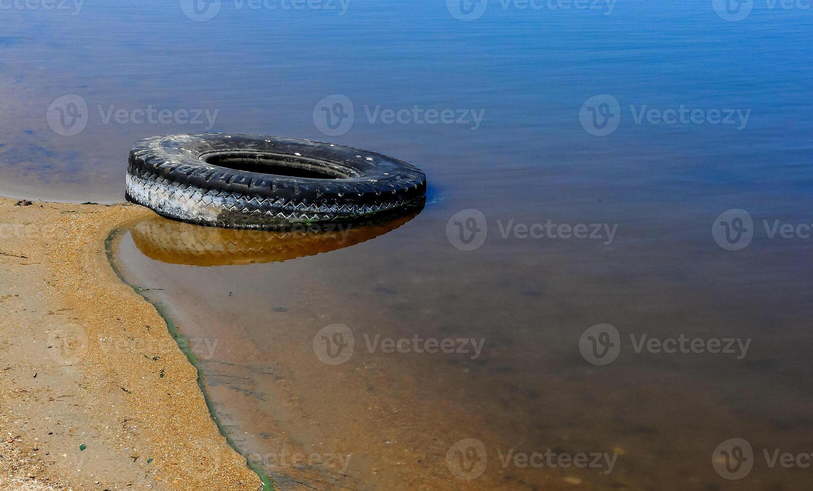 Car tires on the shore Hadzhibey estuary, Ukraine photo