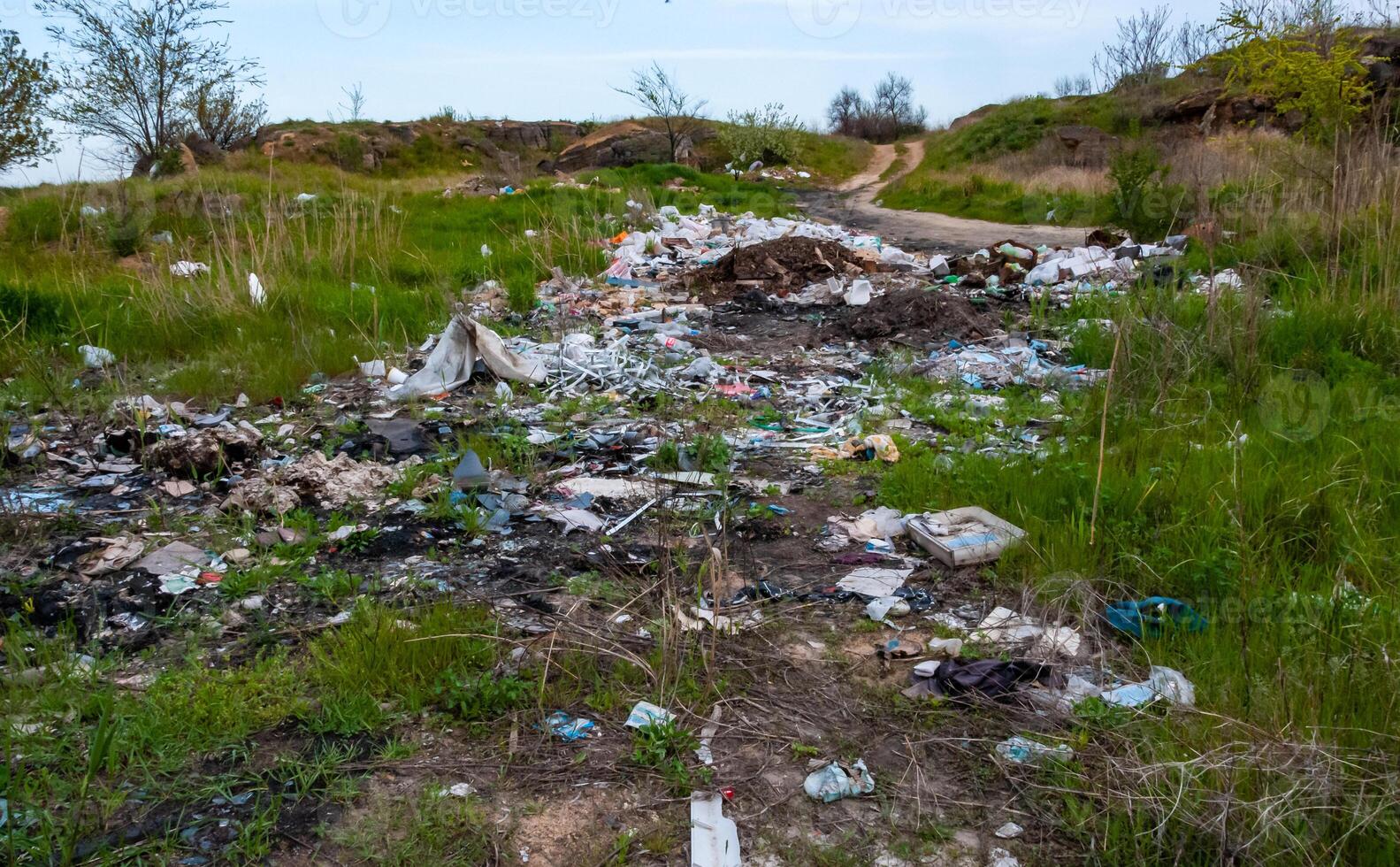 Heaps of plastic trash on the shore of the reservoir. Ecology of nature photo
