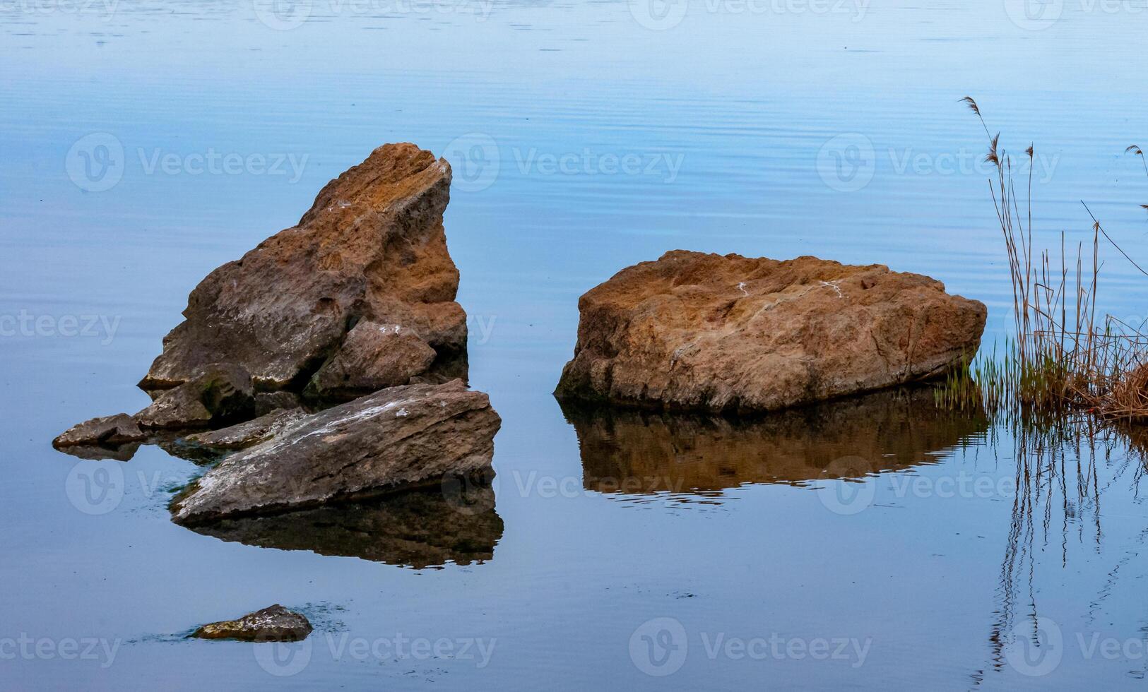Coast with rocks in the water, Hadzhibey estuary. Reflection in water photo
