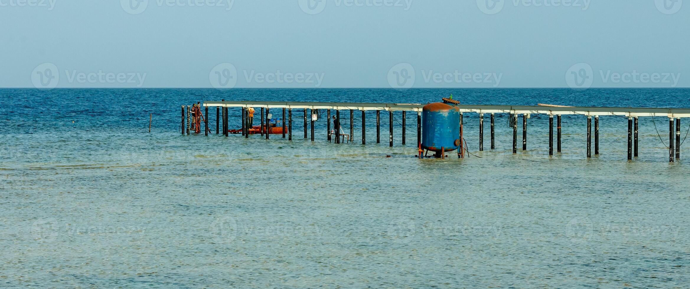 Pier for diving over a coral reef near the shore in the Red Sea photo