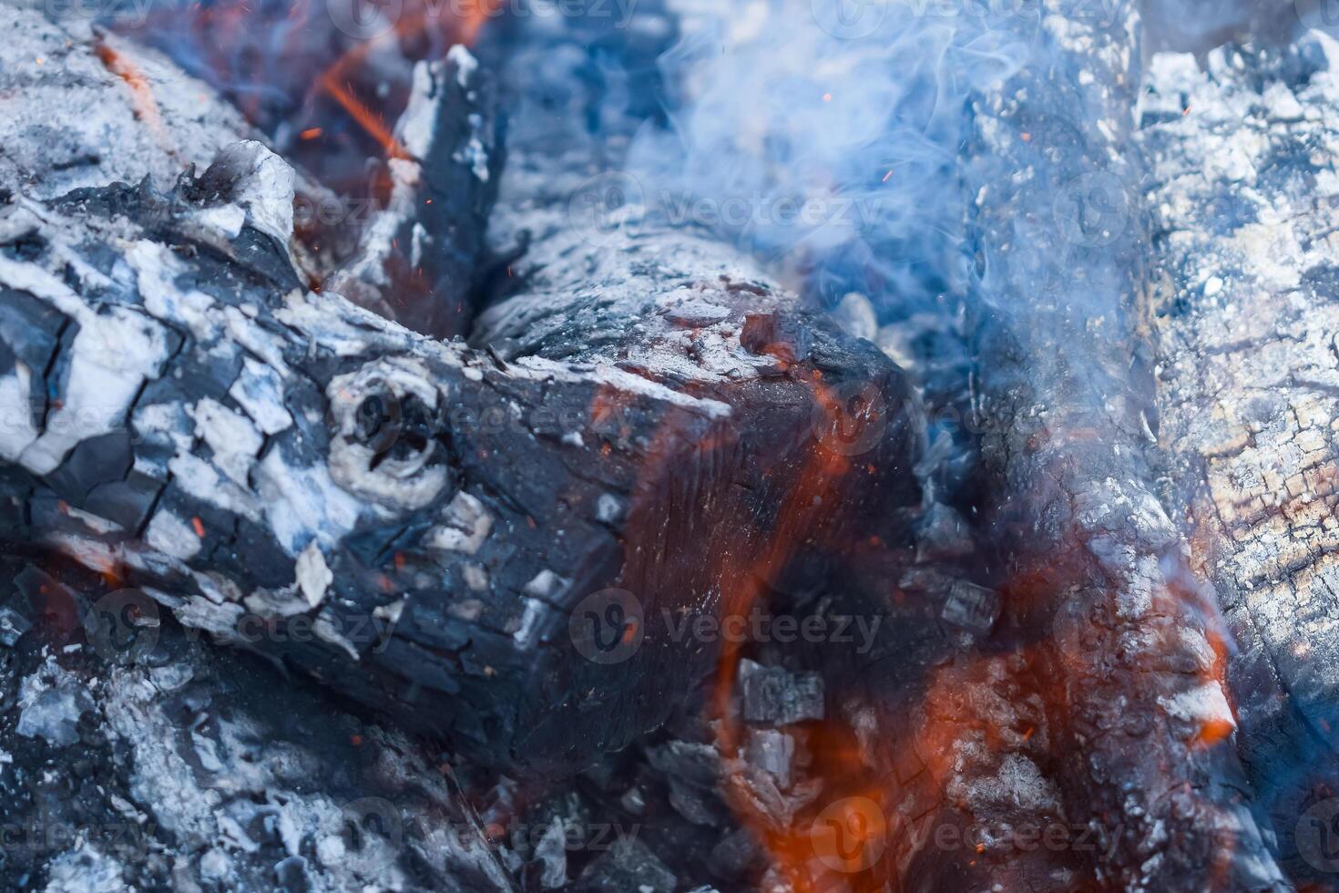 Firewood burning in the brazier, smoldering log coals photo