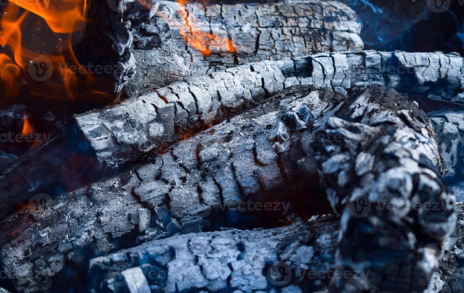 Firewood burning in the brazier, smoldering log coals photo