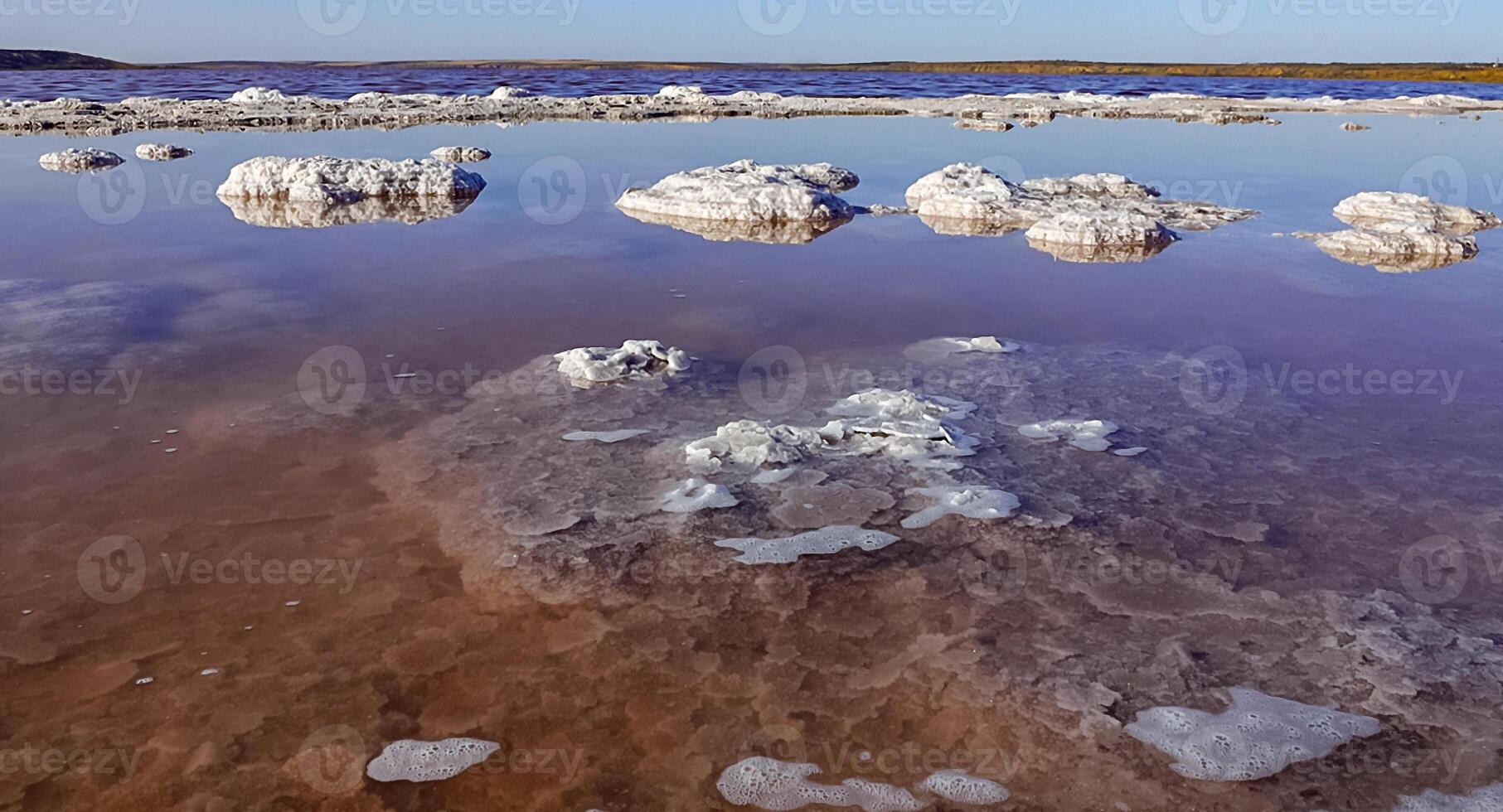 Kuyalnik estuary, Black Sea. Salt crystals cover stones on the shore of a salt lake photo