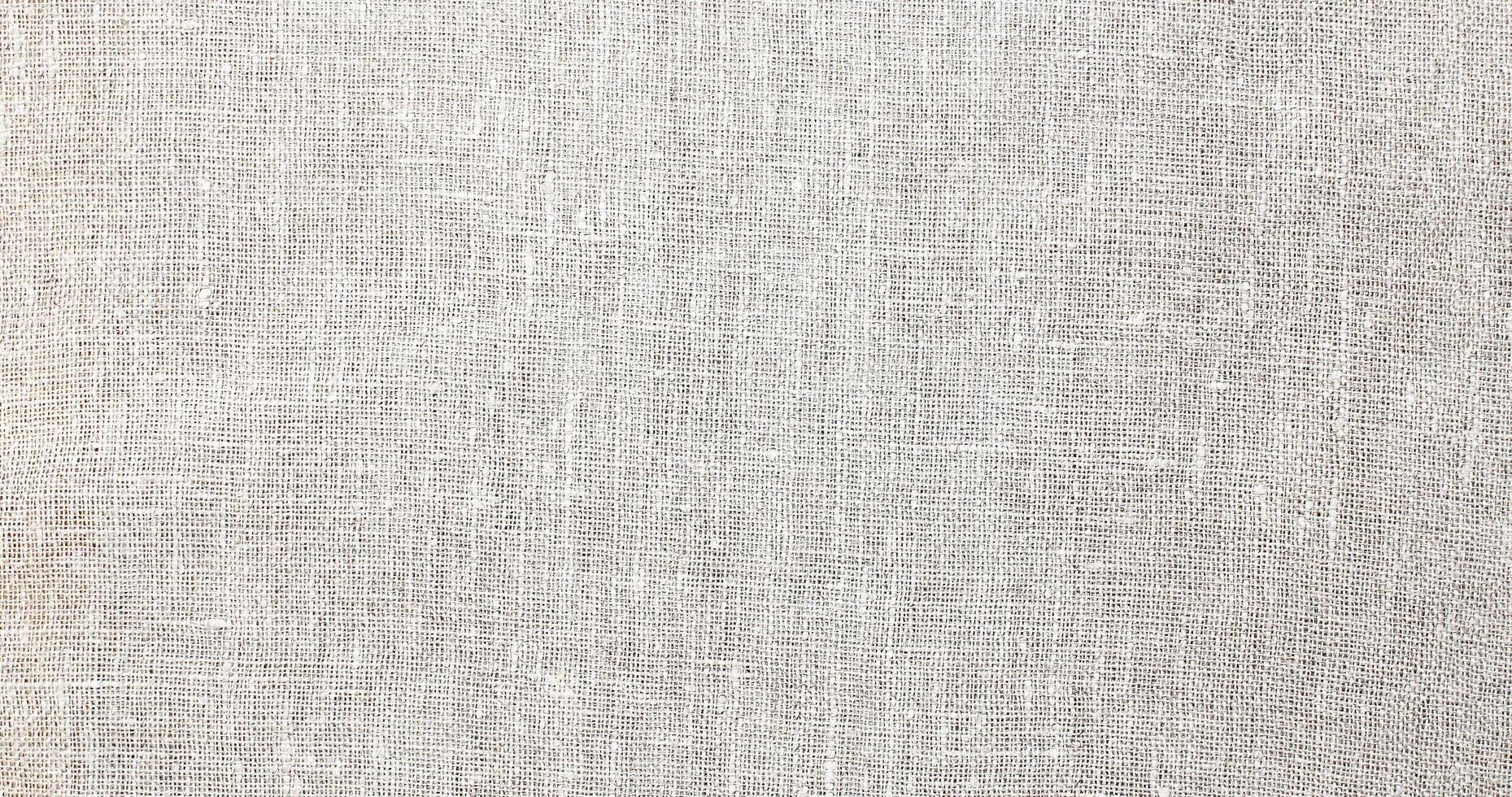 Natural Linen Material Textile Canvas Fabric Texture Background Close-up Detail of Fabric Natural Color Hemp Material Pattern Design Wallpaper. Can be Used as Background or For Graphic Design photo