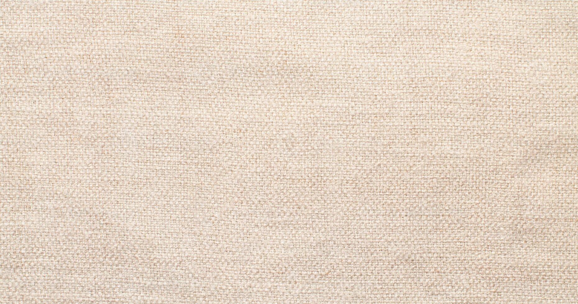 Natural Linen Material Textile Canvas Fabric Texture Background Close-up Detail of Fabric Natural Color Hemp Material Pattern Design Wallpaper. Can be Used as Background or For Graphic Design photo