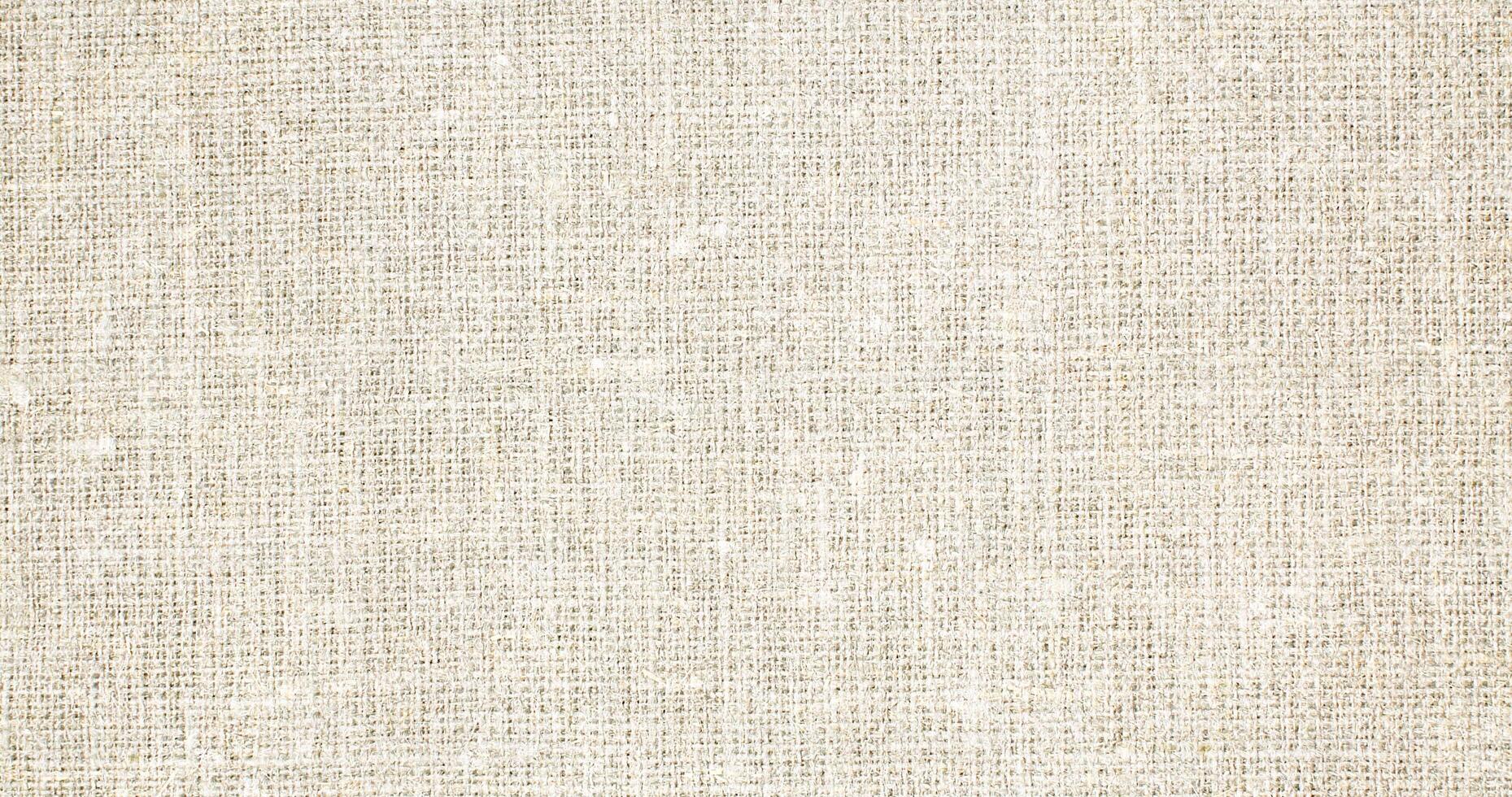 Natural Linen Material Textile Canvas Fabric Texture Background Close-up Detail of Fabric Natural Color Hemp Material Pattern Design Wallpaper. Can be Used as Background or For Graphic Design photo