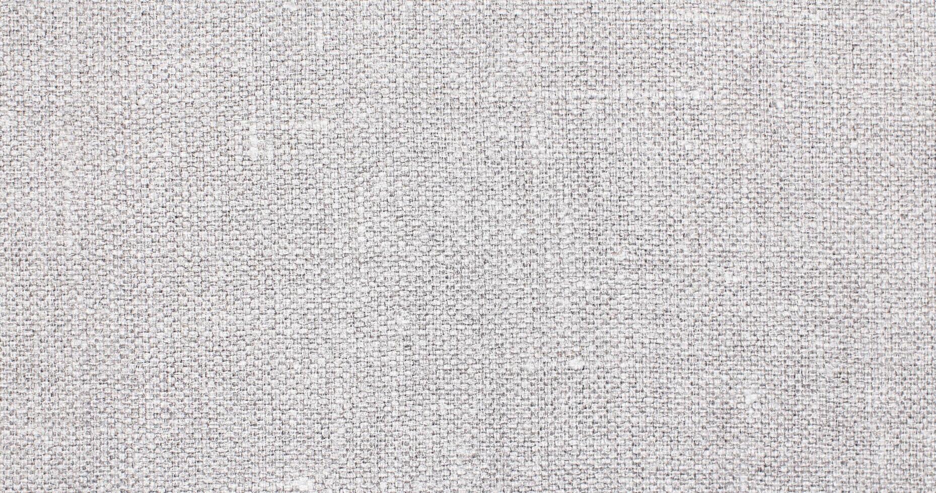 Natural Linen Material Textile Canvas Fabric Texture Background Close-up Detail of Fabric Natural Color Hemp Material Pattern Design Wallpaper. Can be Used as Background or For Graphic Design photo