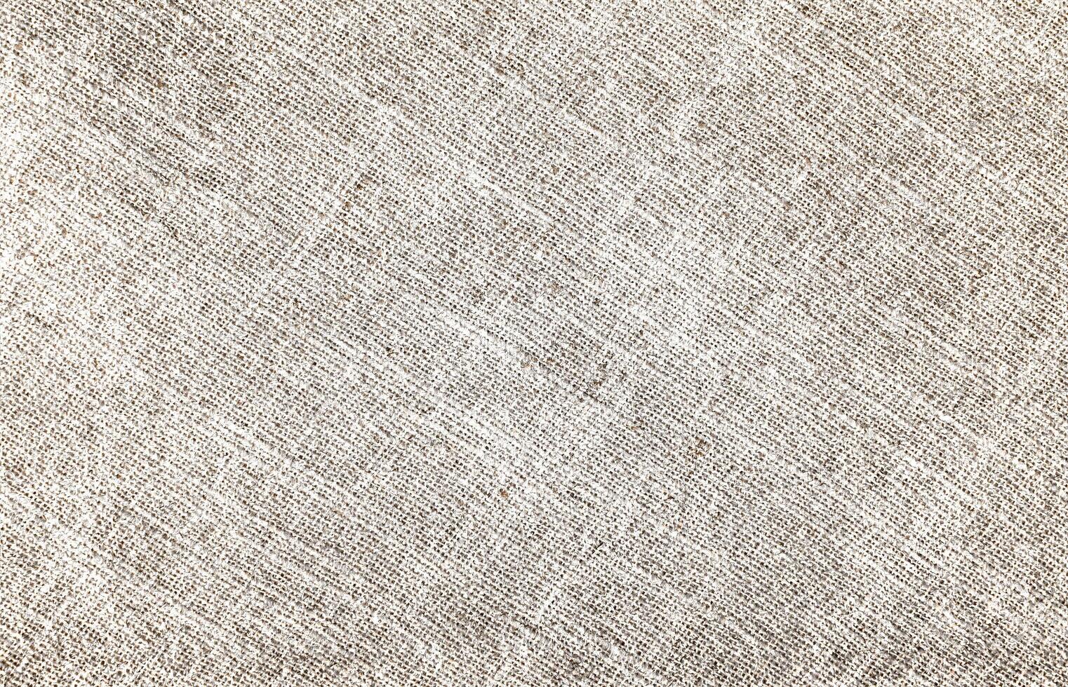 Natural Linen Material Textile Canvas Fabric Texture Background Close-up Detail of Fabric Natural Color Hemp Material Pattern Design Wallpaper. Can be Used as Background or For Graphic Design photo