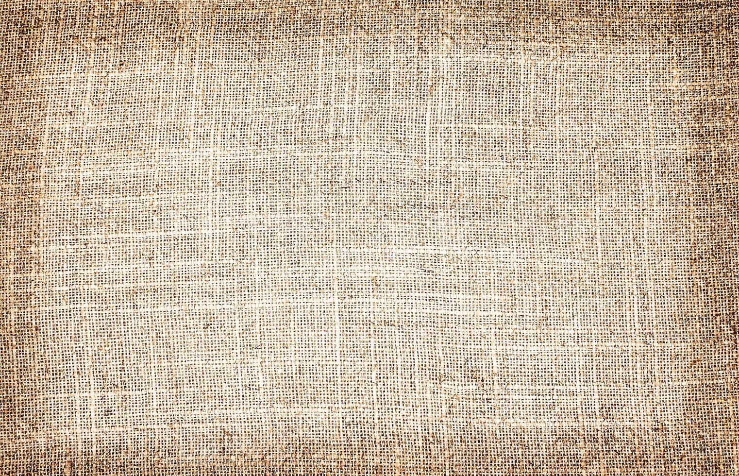 Natural Linen Material Textile Canvas Fabric Texture Background Close-up Detail of Fabric Natural Color Hemp Material Pattern Design Wallpaper. Can be Used as Background or For Graphic Design photo