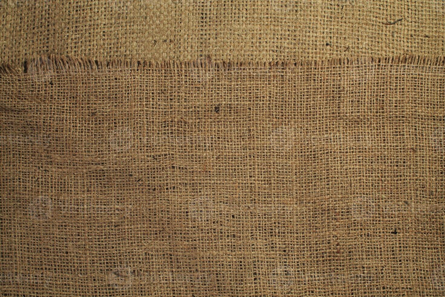 Natural Linen Material Textile Canvas Fabric Texture Background Close-up Detail of Fabric Natural Color Hemp Material Pattern Design Wallpaper. Can be Used as Background or For Graphic Design photo