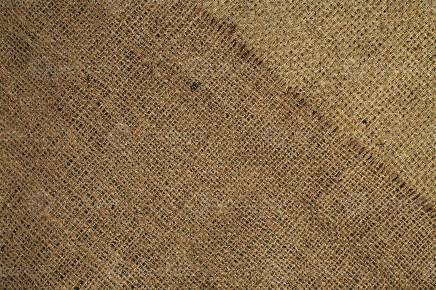 Natural Linen Material Textile Canvas Fabric Texture Background Close-up Detail of Fabric Natural Color Hemp Material Pattern Design Wallpaper. Can be Used as Background or For Graphic Design photo