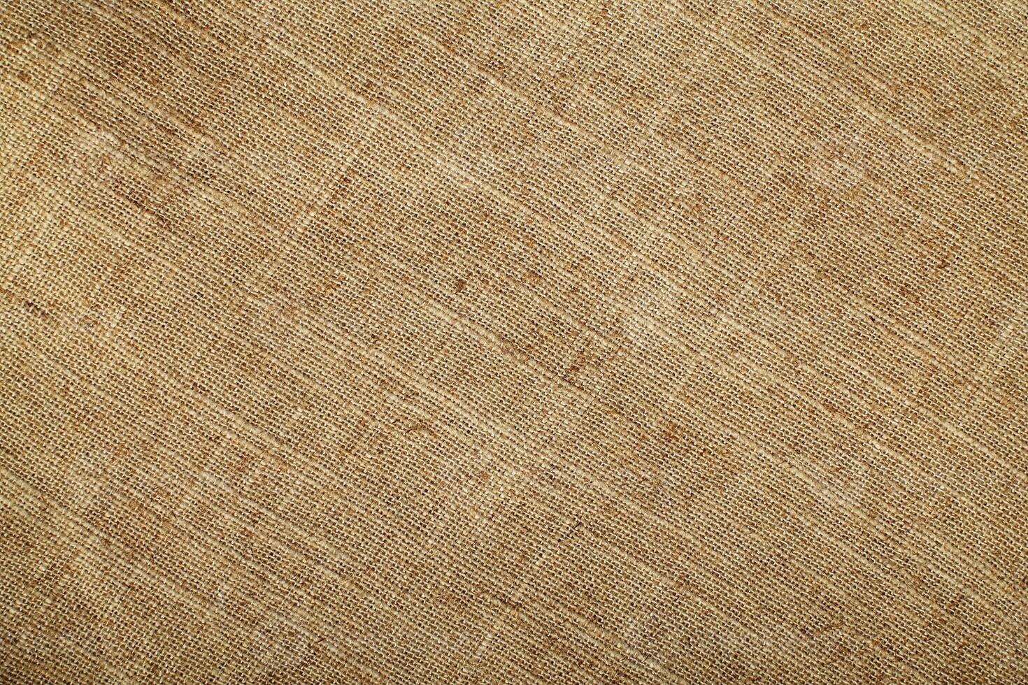 Natural Linen Material Textile Canvas Fabric Texture Background Close-up Detail of Fabric Natural Color Hemp Material Pattern Design Wallpaper. Can be Used as Background or For Graphic Design photo
