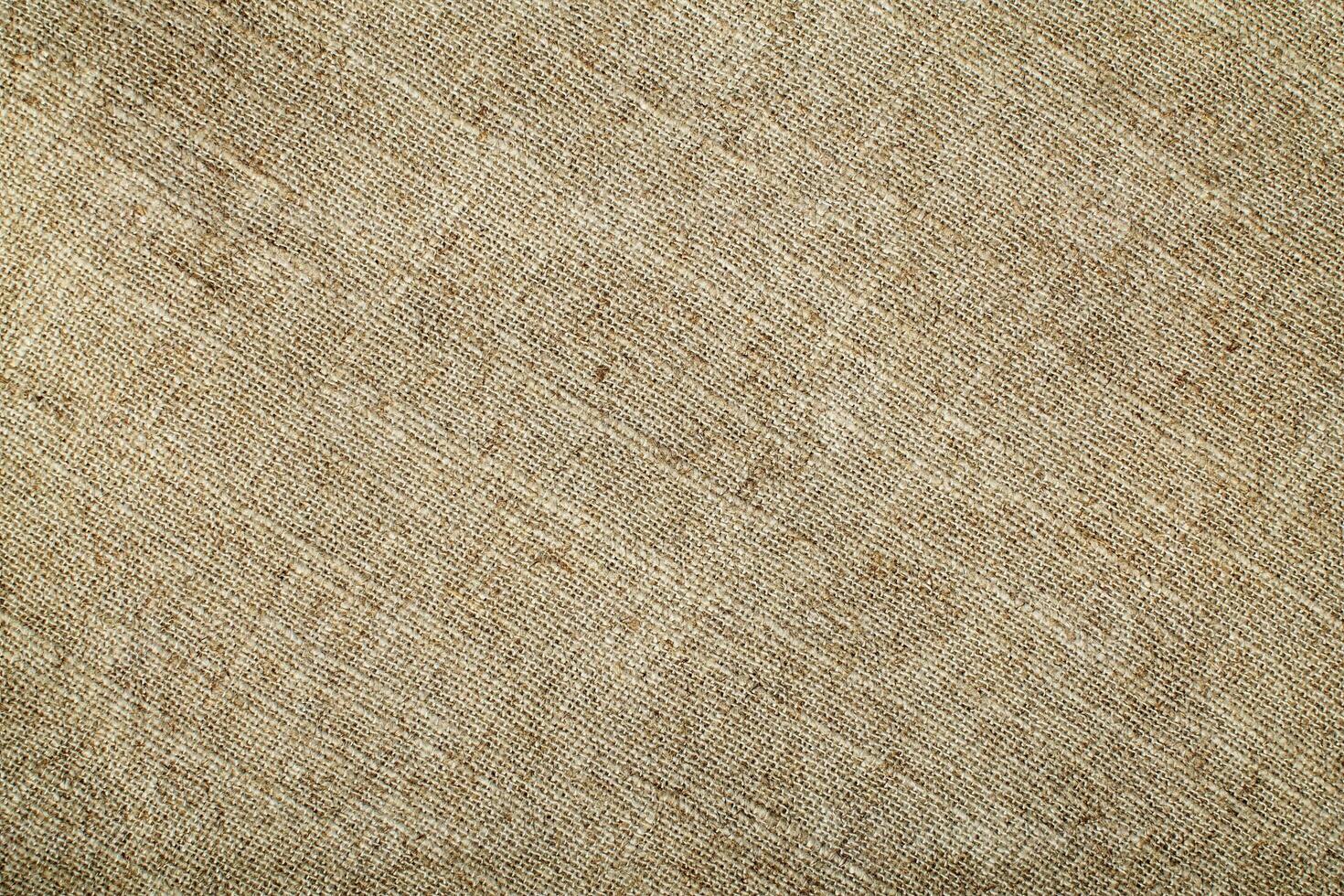 Natural Linen Material Textile Canvas Fabric Texture Background Close-up Detail of Fabric Natural Color Hemp Material Pattern Design Wallpaper. Can be Used as Background or For Graphic Design photo
