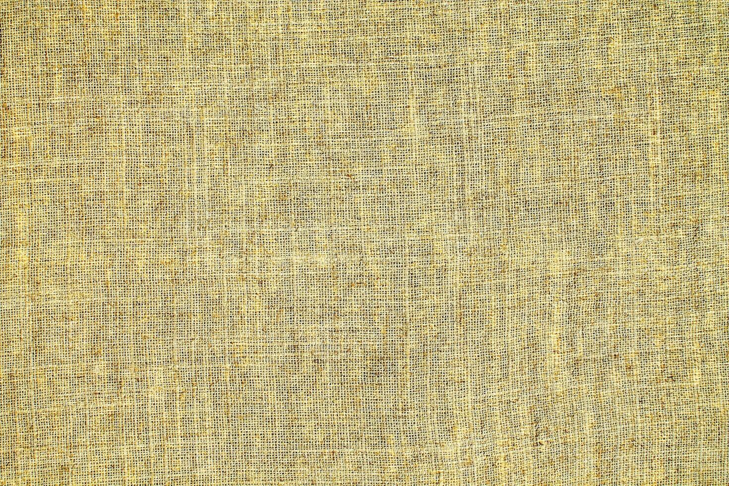 Natural Linen Material Textile Canvas Fabric Texture Background Close-up Detail of Fabric Natural Color Hemp Material Pattern Design Wallpaper. Can be Used as Background or For Graphic Design photo