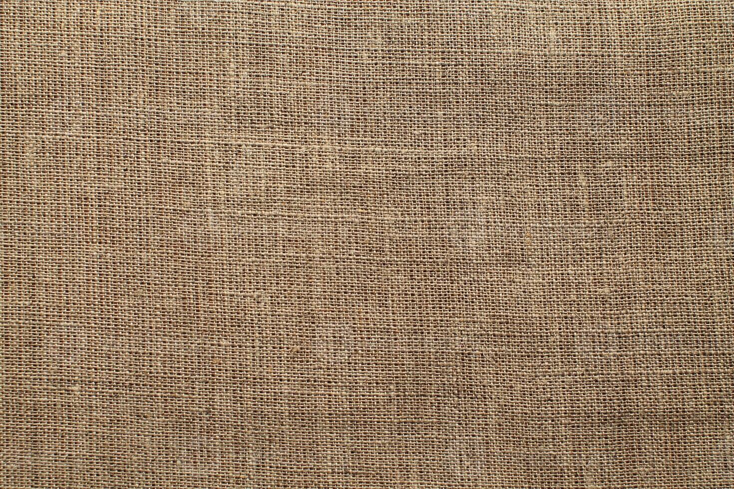 Natural Linen Material Textile Canvas Fabric Texture Background Close-up Detail of Fabric Natural Color Hemp Material Pattern Design Wallpaper. Can be Used as Background or For Graphic Design photo
