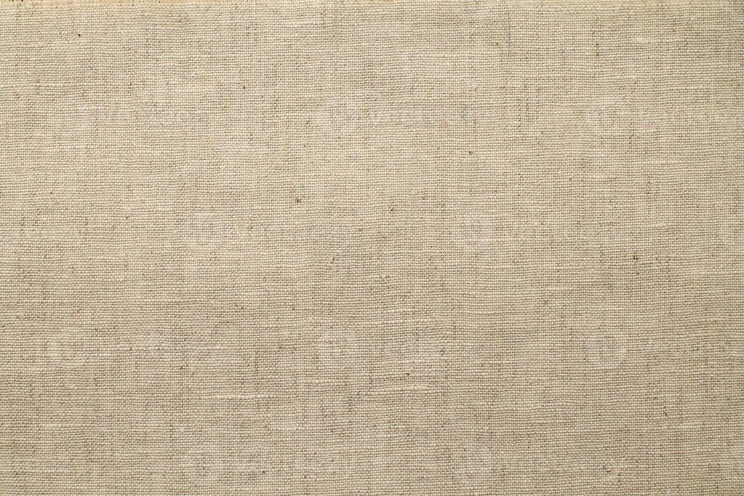 Natural Linen Material Textile Canvas Fabric Texture Background Close-up Detail of Fabric Natural Color Hemp Material Pattern Design Wallpaper. Can be Used as Background or For Graphic Design photo