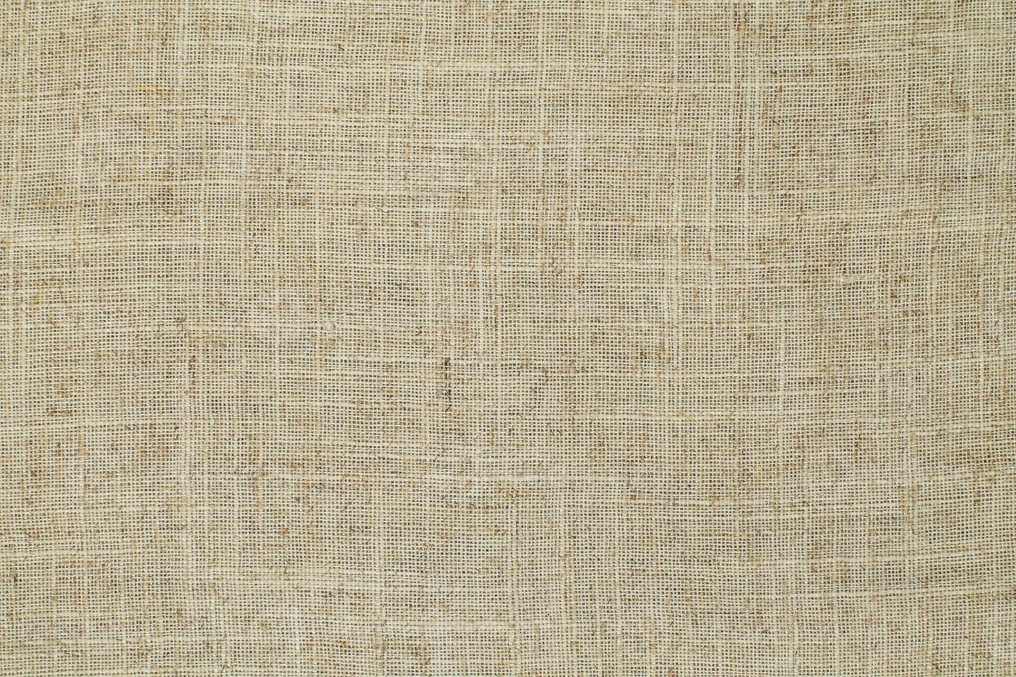 Natural Linen Material Textile Canvas Fabric Texture Background Close-up Detail of Fabric Natural Color Hemp Material Pattern Design Wallpaper. Can be Used as Background or For Graphic Design photo
