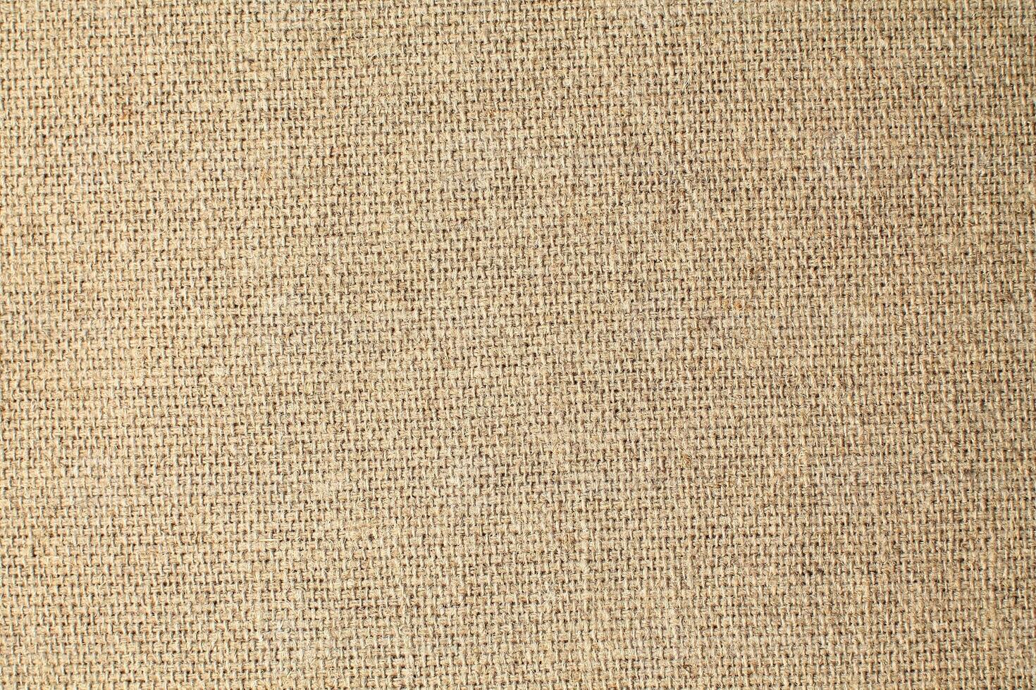 Natural Linen Material Textile Canvas Fabric Texture Background Close-up Detail of Fabric Natural Color Hemp Material Pattern Design Wallpaper. Can be Used as Background or For Graphic Design photo