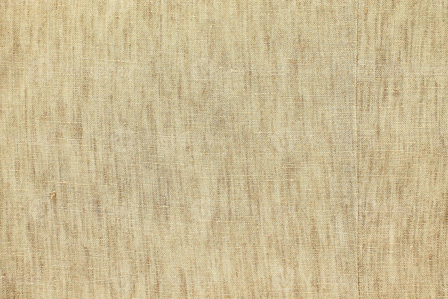 Natural Linen Material Textile Canvas Fabric Texture Background Close-up Detail of Fabric Natural Color Hemp Material Pattern Design Wallpaper. Can be Used as Background or For Graphic Design photo