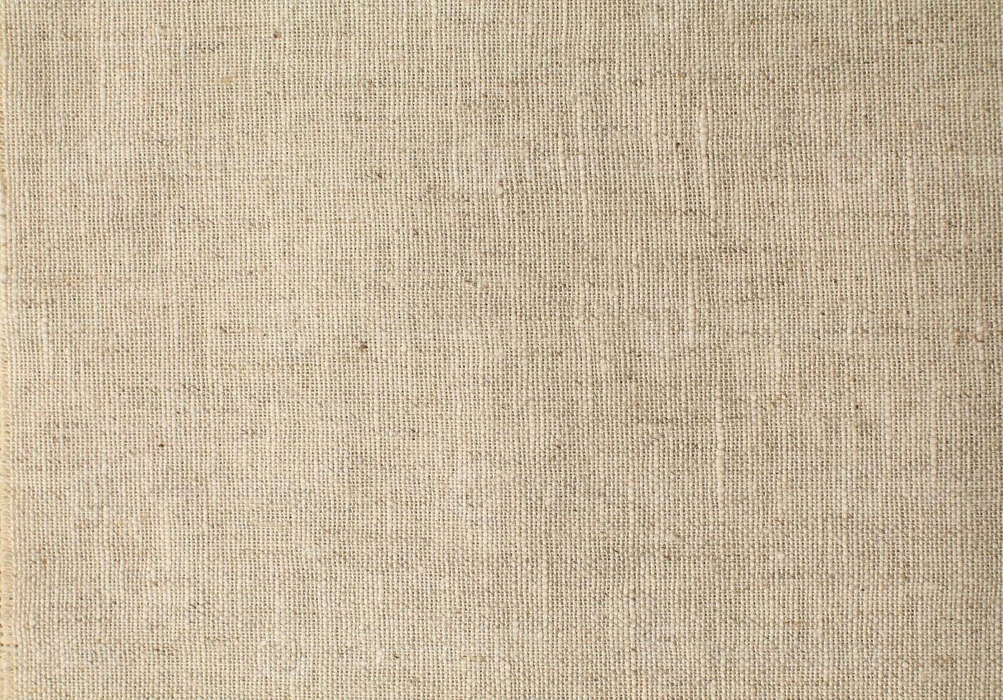 Natural Linen Material Textile Canvas Fabric Texture Background Close-up Detail of Fabric Natural Color Hemp Material Pattern Design Wallpaper. Can be Used as Background or For Graphic Design photo