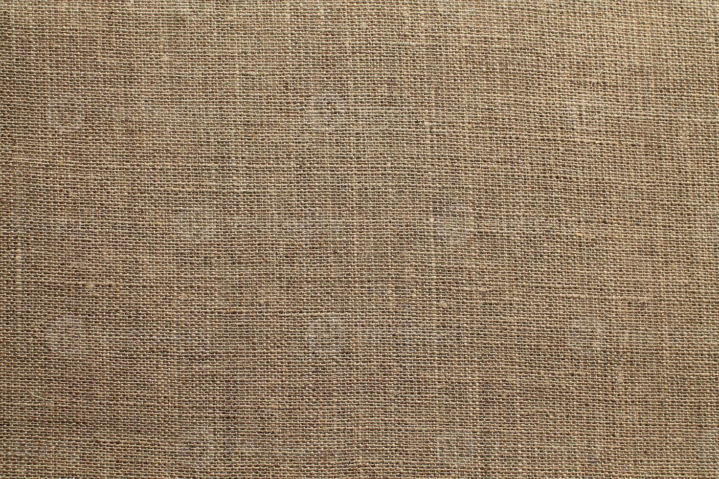 Natural Linen Material Textile Canvas Fabric Texture Background Close-up Detail of Fabric Natural Color Hemp Material Pattern Design Wallpaper. Can be Used as Background or For Graphic Design photo