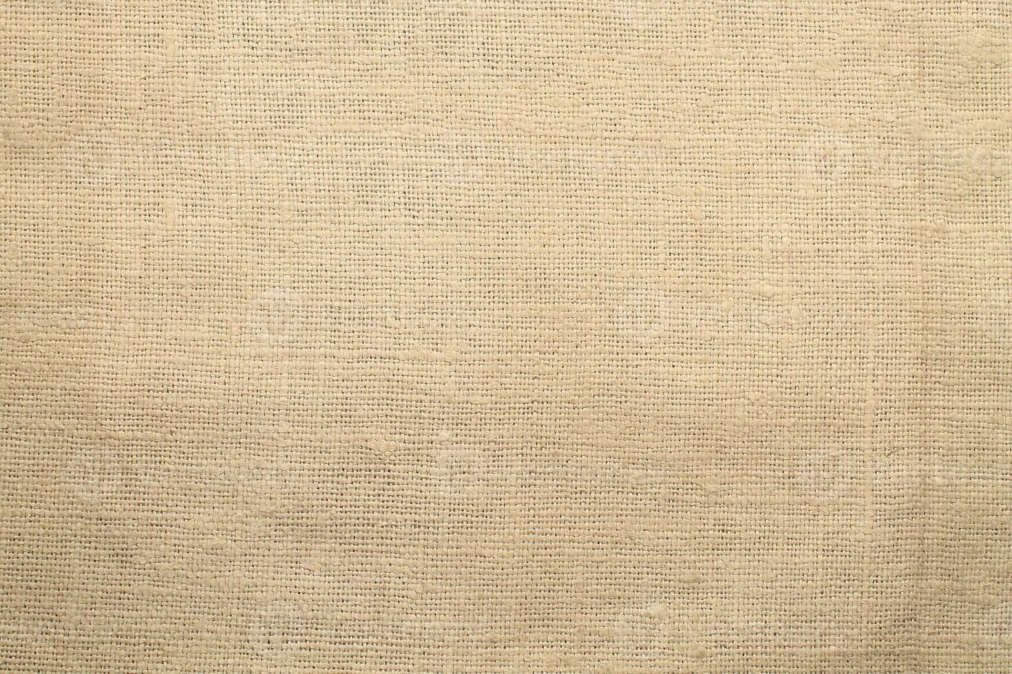 Natural Linen Material Textile Canvas Fabric Texture Background Close-up Detail of Fabric Natural Color Hemp Material Pattern Design Wallpaper. Can be Used as Background or For Graphic Design photo