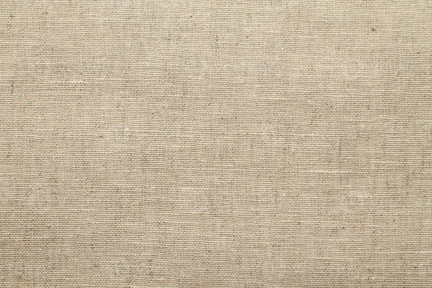 Natural Linen Material Textile Canvas Fabric Texture Background Close-up Detail of Fabric Natural Color Hemp Material Pattern Design Wallpaper. Can be Used as Background or For Graphic Design photo