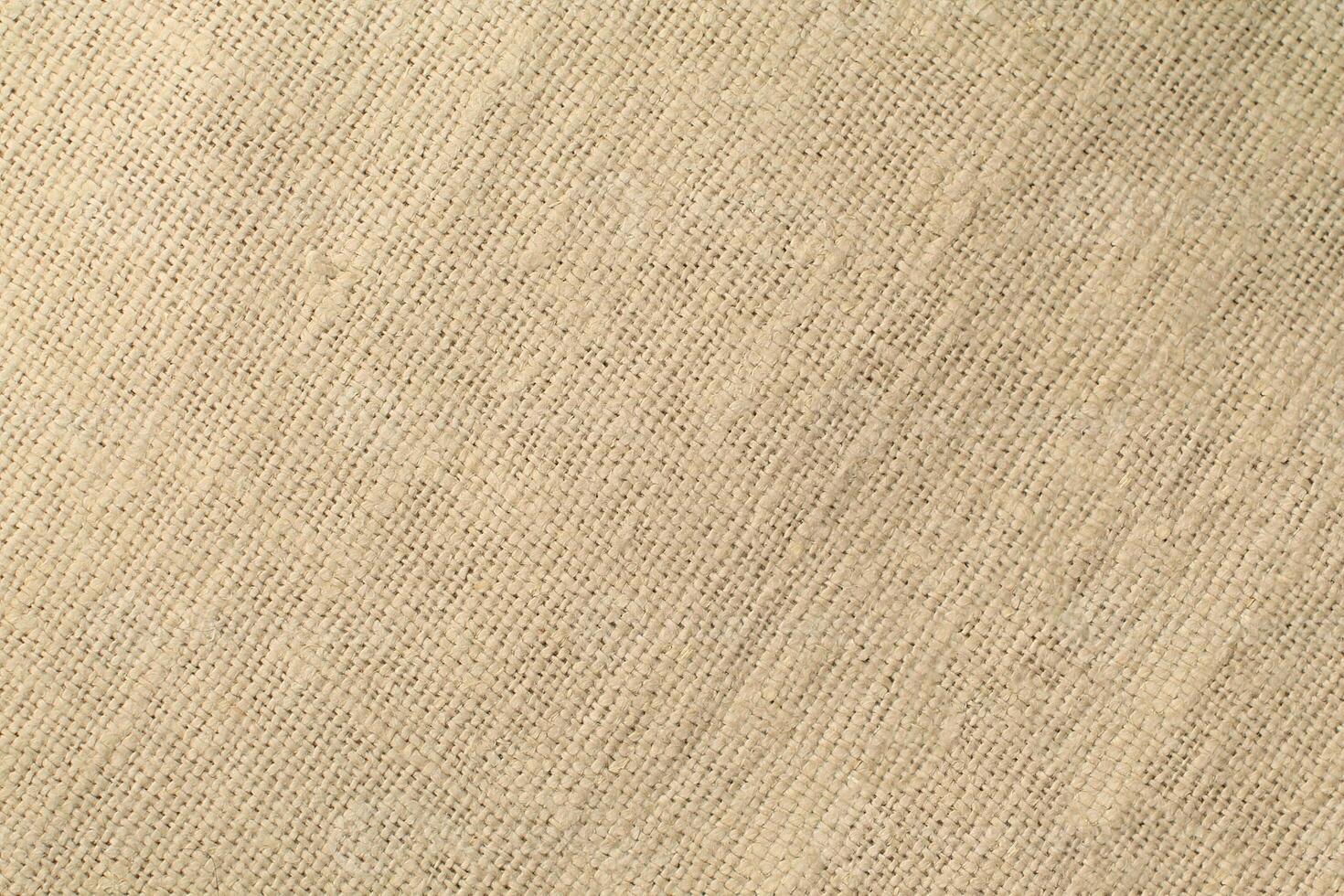 Natural Linen Material Textile Canvas Fabric Texture Background Close-up Detail of Fabric Natural Color Hemp Material Pattern Design Wallpaper. Can be Used as Background or For Graphic Design photo