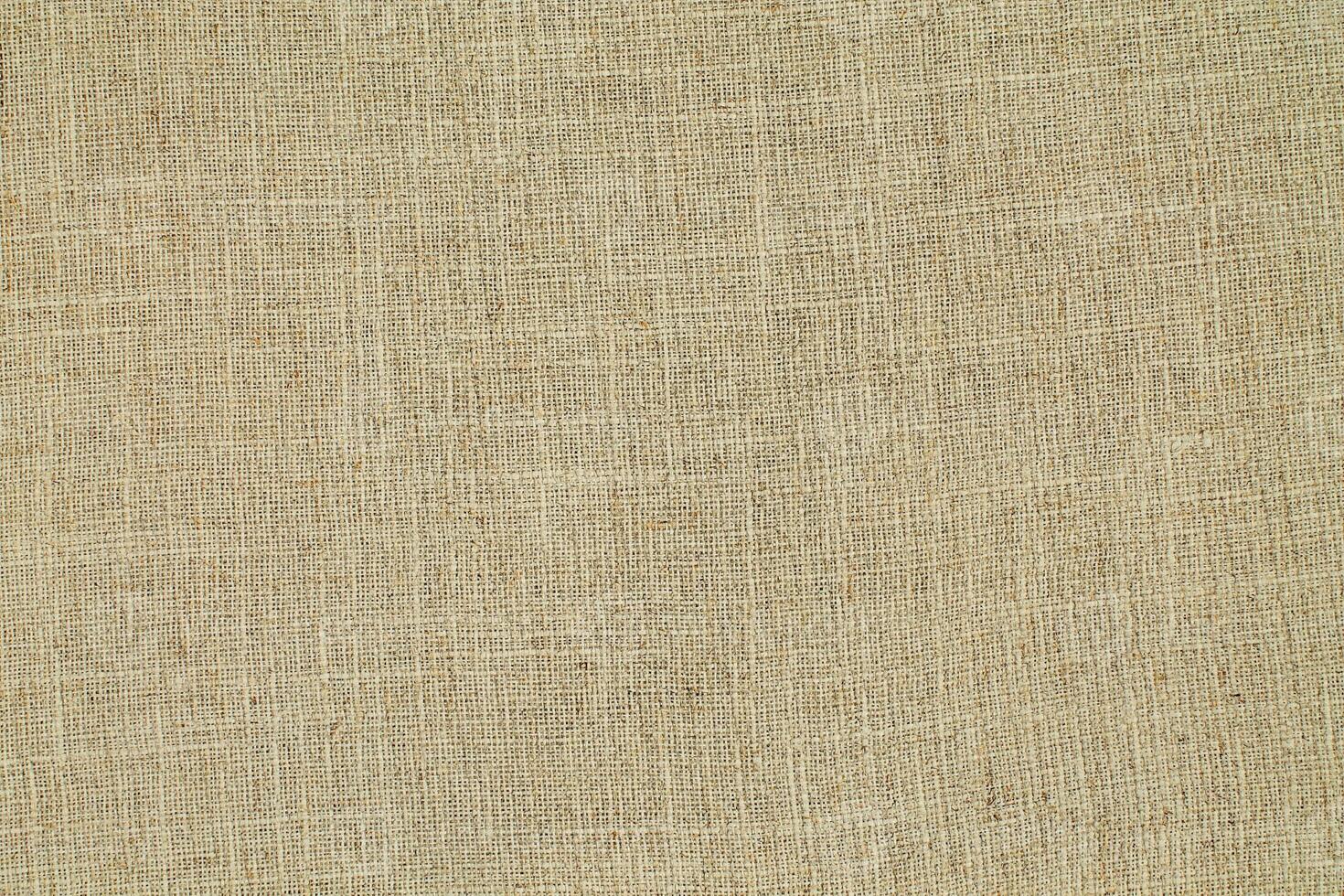 Natural Linen Material Textile Canvas Fabric Texture Background Close-up Detail of Fabric Natural Color Hemp Material Pattern Design Wallpaper. Can be Used as Background or For Graphic Design photo