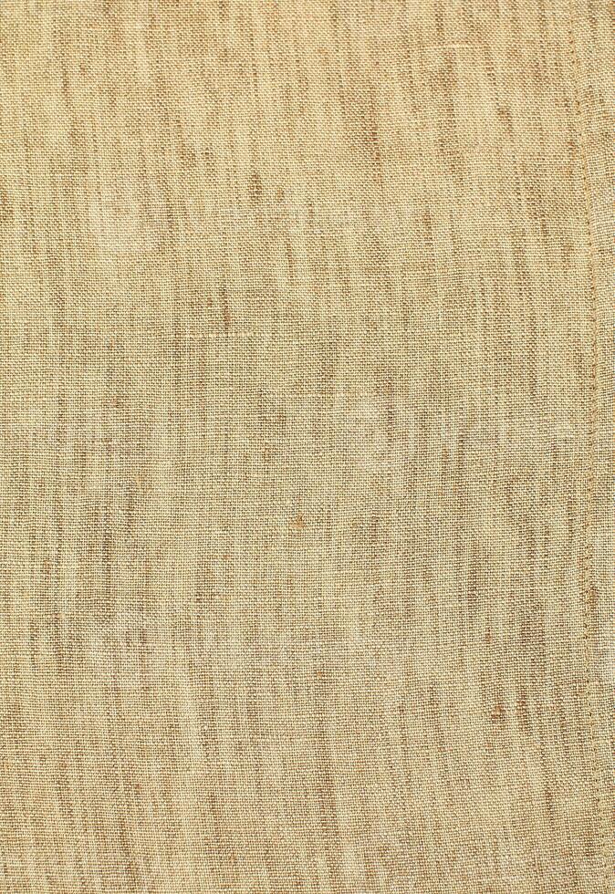Natural Linen Material Textile Canvas Fabric Texture Background Close-up Detail of Fabric Natural Color Hemp Material Pattern Design Wallpaper. Can be Used as Background or For Graphic Design photo