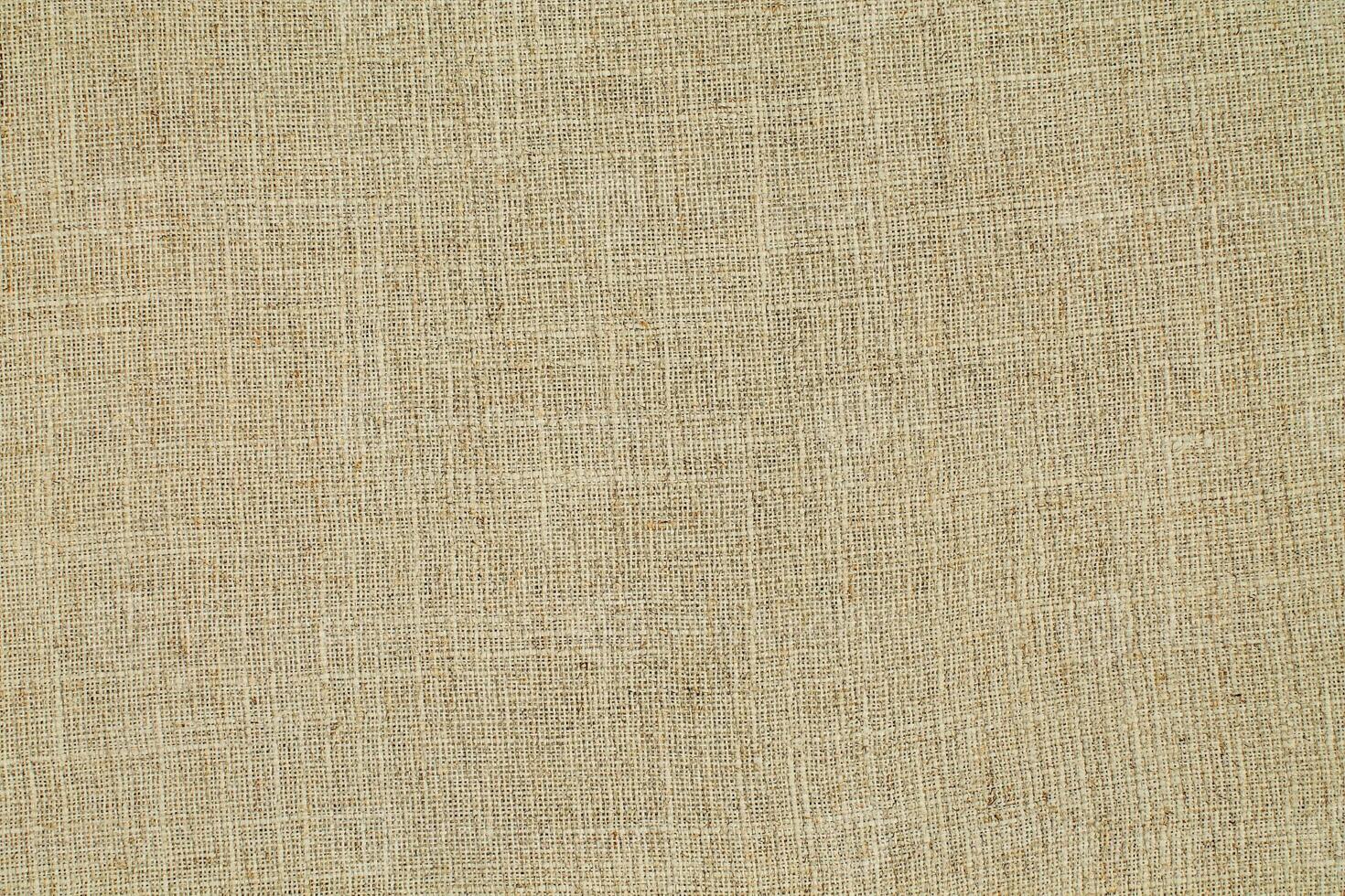 Natural Linen Material Textile Canvas Fabric Texture Background Close-up Detail of Fabric Natural Color Hemp Material Pattern Design Wallpaper. Can be Used as Background or For Graphic Design photo