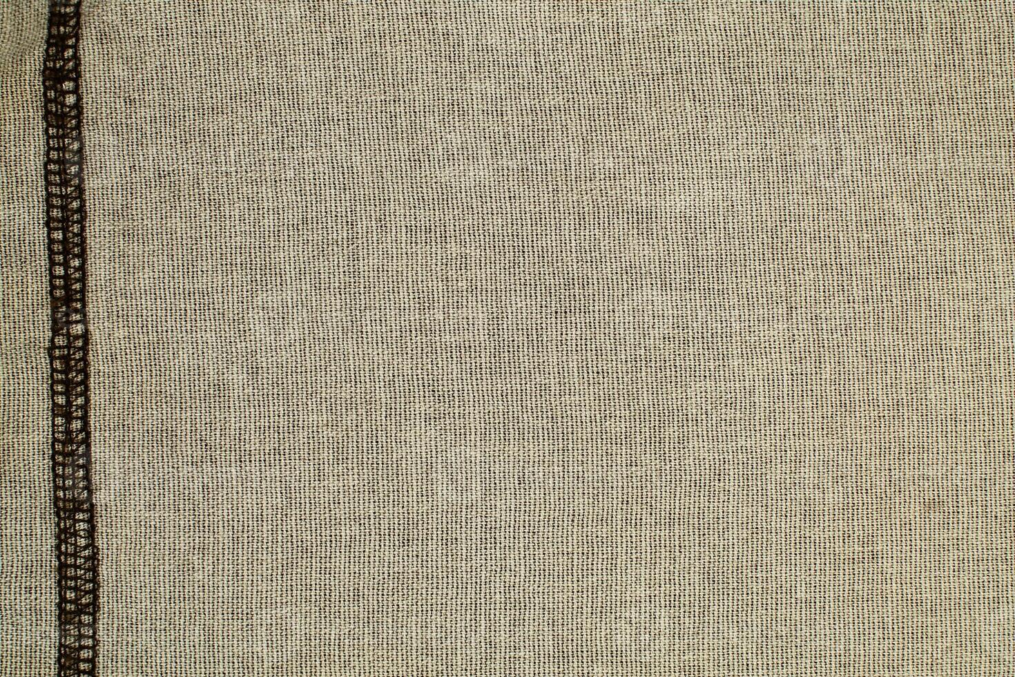 Natural Linen Material Textile Canvas Fabric Texture Background Close-up Detail of Fabric Natural Color Hemp Material Pattern Design Wallpaper. Can be Used as Background or For Graphic Design photo