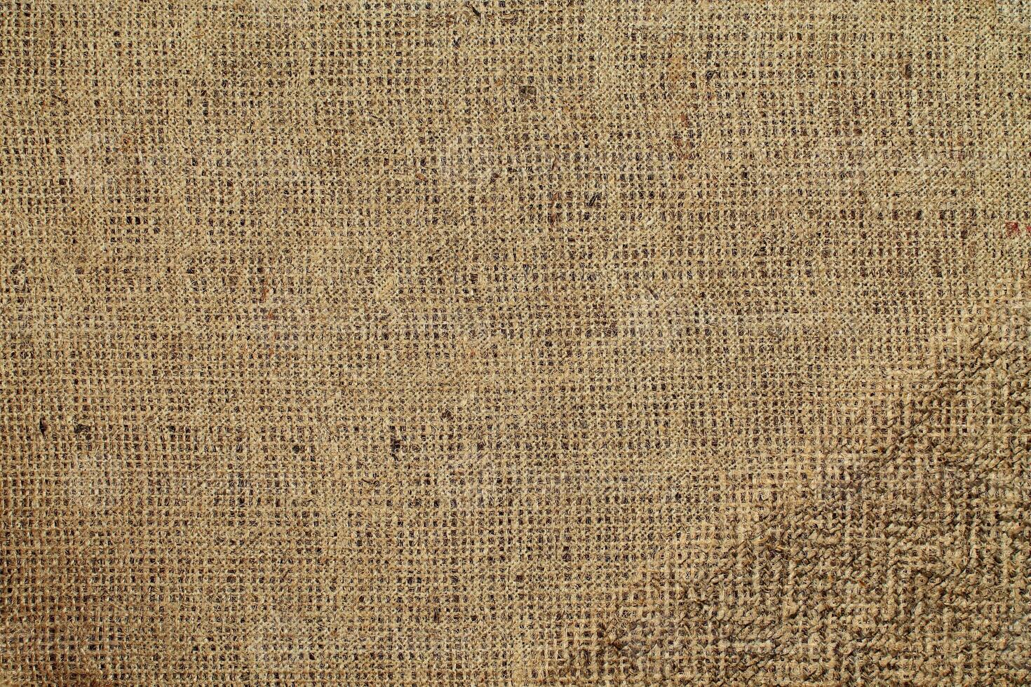 Natural Linen Material Textile Canvas Fabric Texture Background Close-up Detail of Fabric Natural Color Hemp Material Pattern Design Wallpaper. Can be Used as Background or For Graphic Design photo