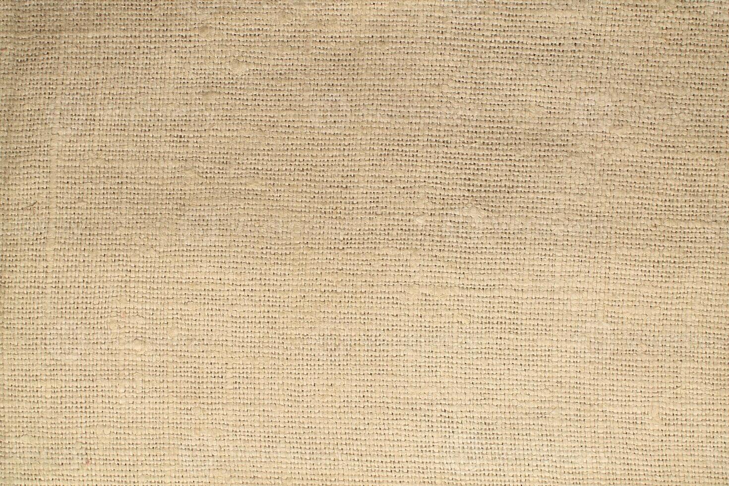 Natural Linen Material Textile Canvas Fabric Texture Background Close-up Detail of Fabric Natural Color Hemp Material Pattern Design Wallpaper. Can be Used as Background or For Graphic Design photo