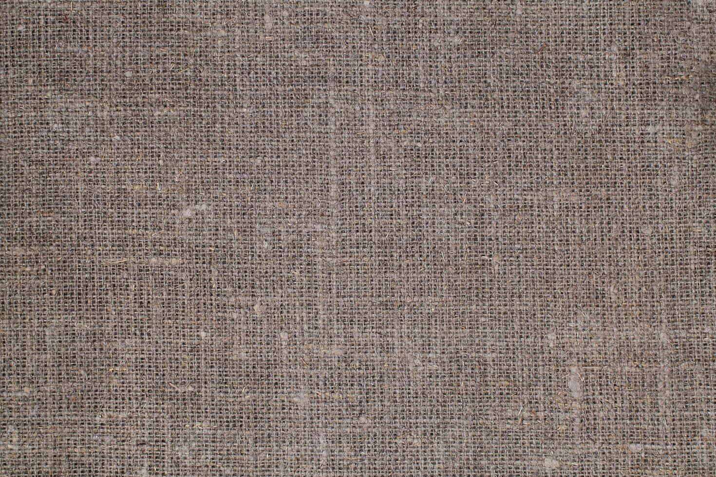 Natural Linen Material Textile Canvas Fabric Texture Background Close-up Detail of Fabric Natural Color Hemp Material Pattern Design Wallpaper. Can be Used as Background or For Graphic Design photo