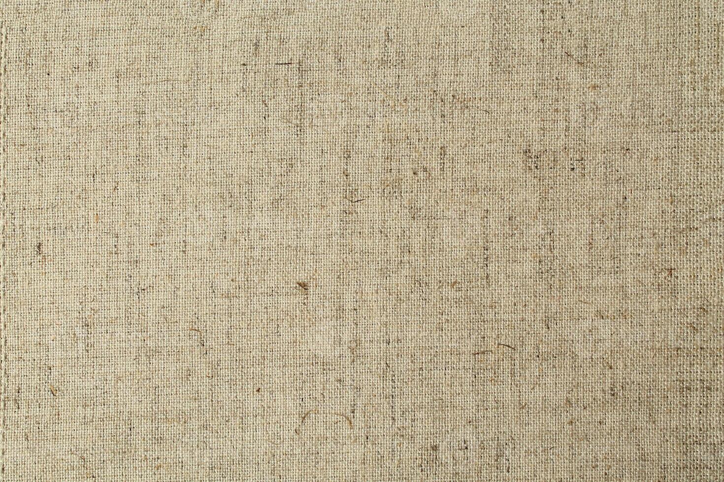 Natural Linen Material Textile Canvas Fabric Texture Background Close-up Detail of Fabric Natural Color Hemp Material Pattern Design Wallpaper. Can be Used as Background or For Graphic Design photo