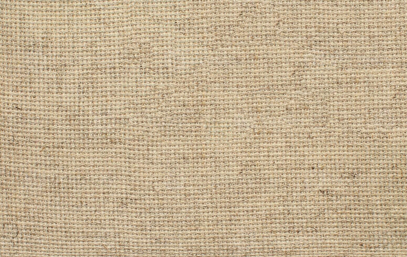 Natural Linen Material Textile Canvas Fabric Texture Background Close-up Detail of Fabric Natural Color Hemp Material Pattern Design Wallpaper. Can be Used as Background or For Graphic Design photo