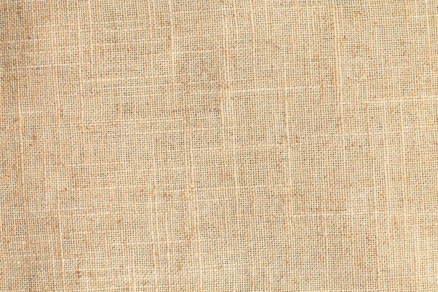 Natural Linen Material Textile Canvas Fabric Texture Background Close-up Detail of Fabric Natural Color Hemp Material Pattern Design Wallpaper. Can be Used as Background or For Graphic Design photo