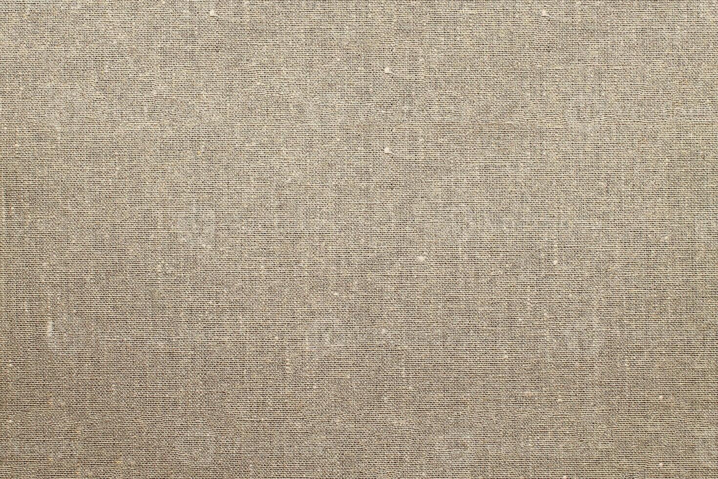 Natural Linen Material Textile Canvas Fabric Texture Background Close-up Detail of Fabric Natural Color Hemp Material Pattern Design Wallpaper. Can be Used as Background or For Graphic Design photo