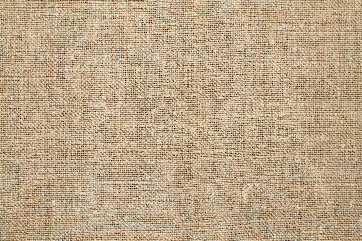 Natural Linen Material Textile Canvas Fabric Texture Background Close-up Detail of Fabric Natural Color Hemp Material Pattern Design Wallpaper. Can be Used as Background or For Graphic Design photo