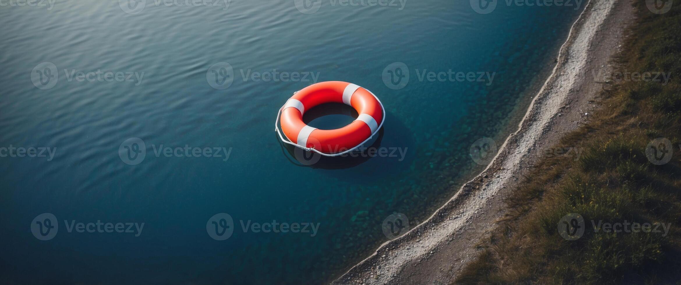 Top view of lifebuoy floating on top of blue water. photo