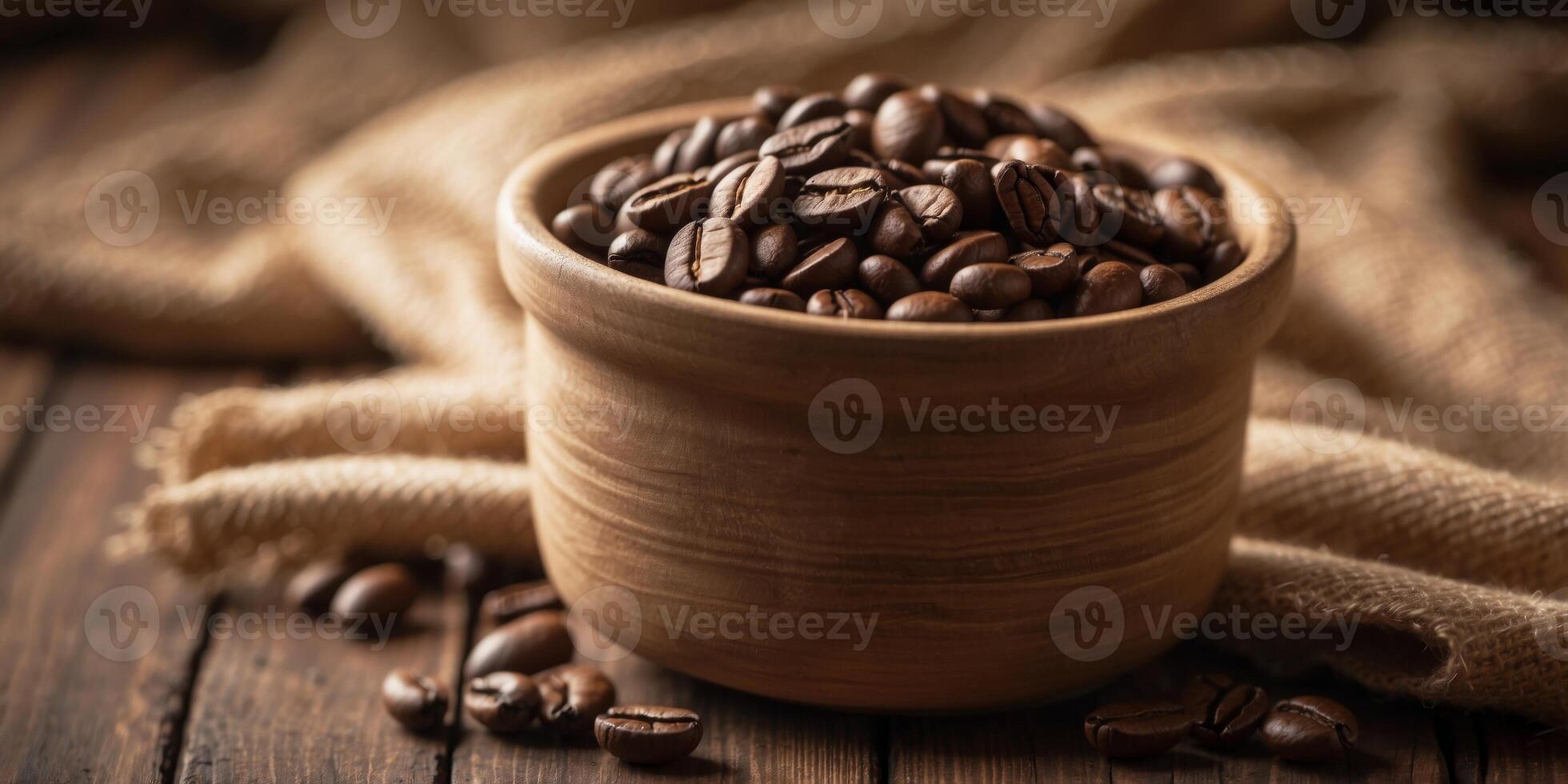 Bowl of coffee beans on rustic table with burlap sacks. photo